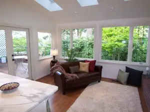 photo of a sun room that has sun shining through the skylights